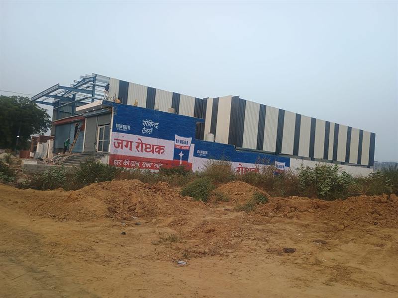 Pre-engineered steel building under construction with site levelling in progress