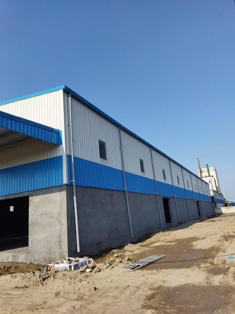 Side elevation of a blue and white clad industrial shed