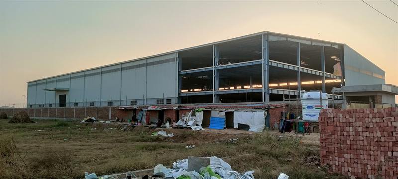 Wide-span warehouse under construction with open bays